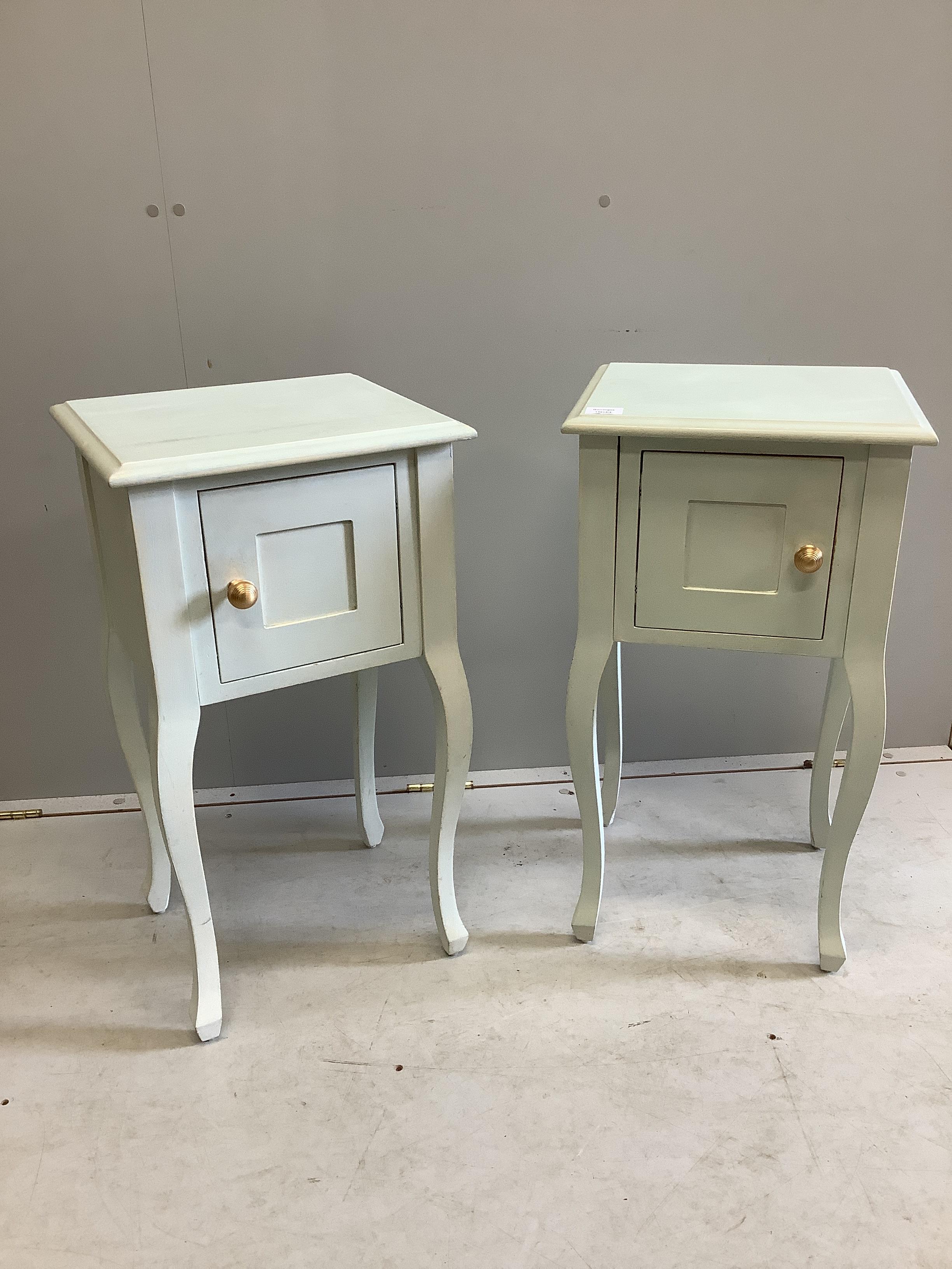 A pair of reproduction painted bedside cabinets, width 38cm, depth 34cm, height 71cm